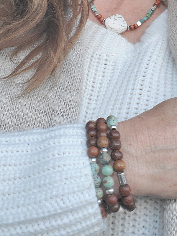 earthy gemstone aromatherapy bracelet stack on arm with white sweater