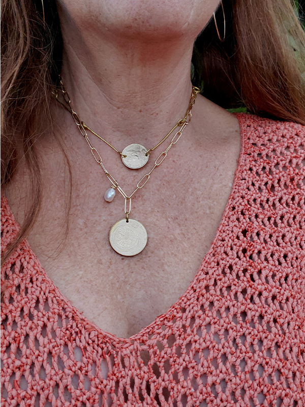 layered coin jewelry being worn