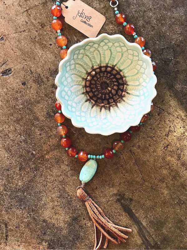 orange gemstone tassel necklace and ceramic flower bowl