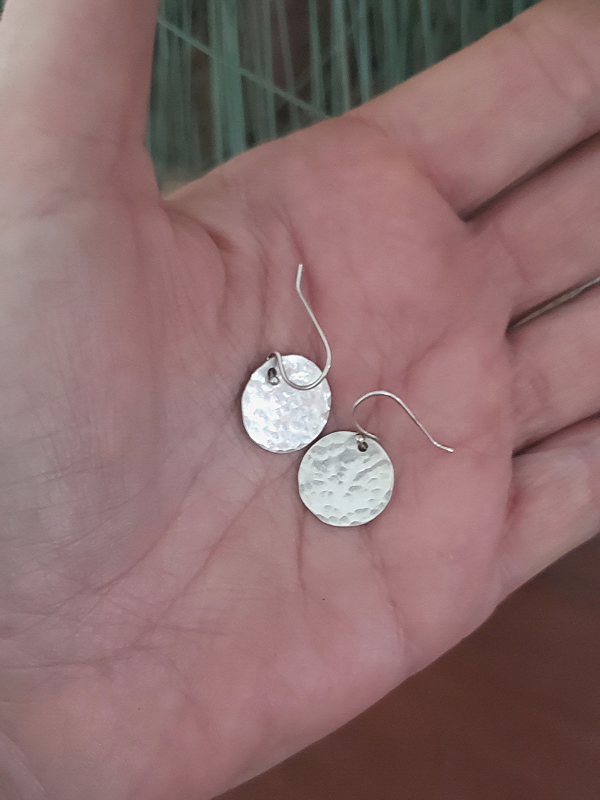 sterling disc earrings in palm of hand
