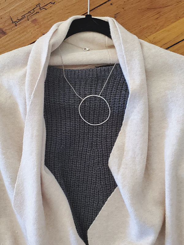 gray knit top with peach sweater silver circle necklace