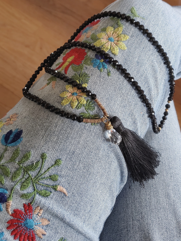flowered jeans and a black gemstone tassel necklace