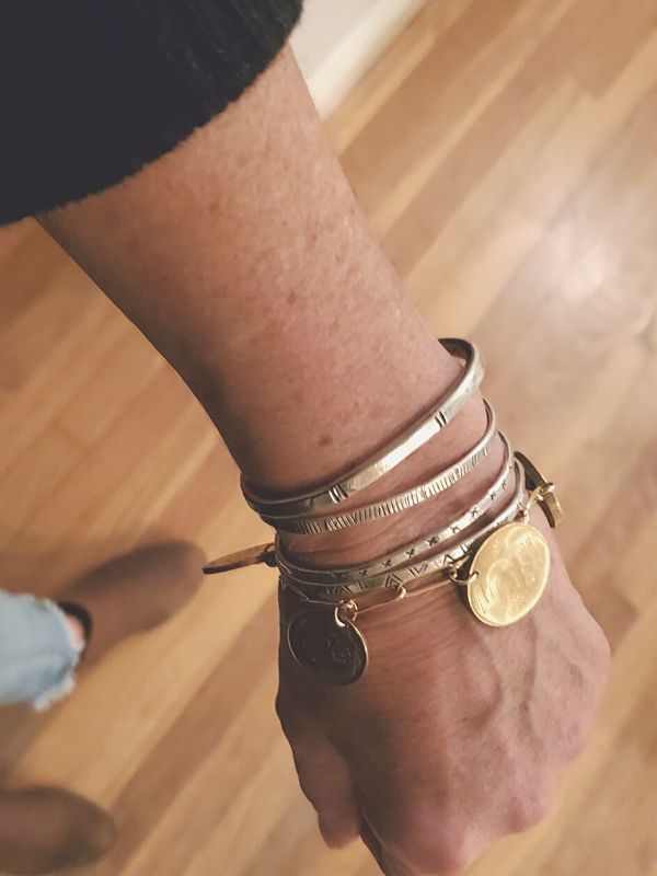 silver cuffs with gold coin bracelet on arm