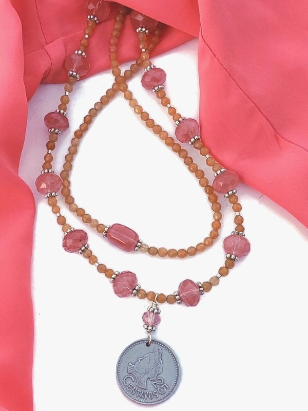 pink blouse with orange & pink necklaces