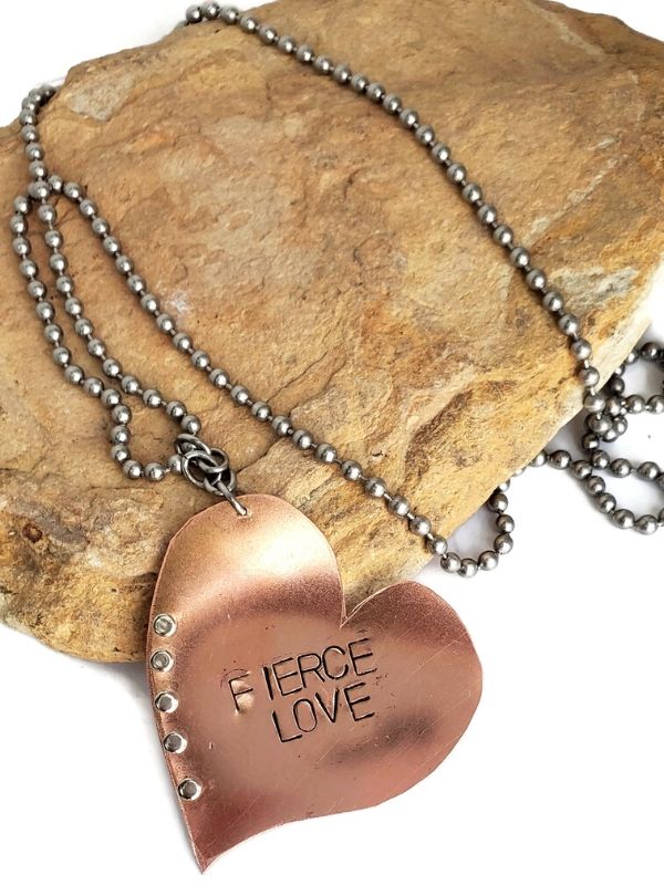 copper heart necklace on a rock