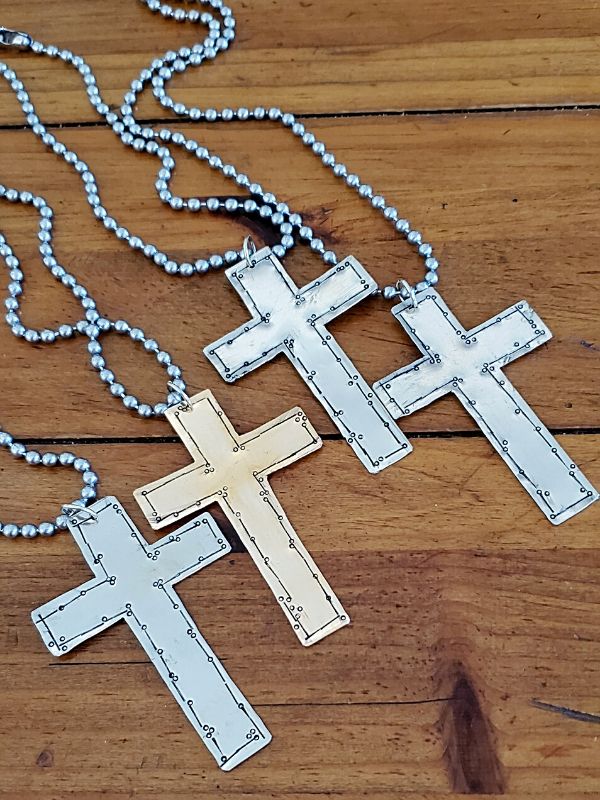 a row of cool cross necklaces on wood