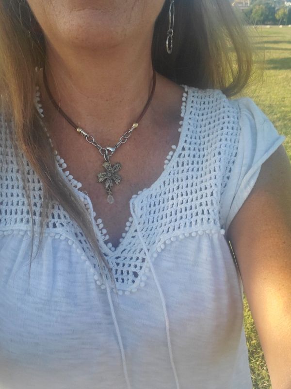 wearing metal flower necklace in the park