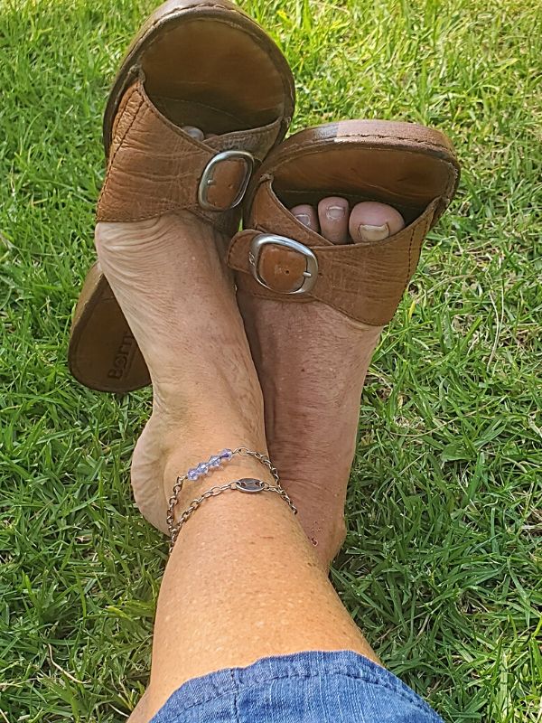 crossed legs in grass with anklets
