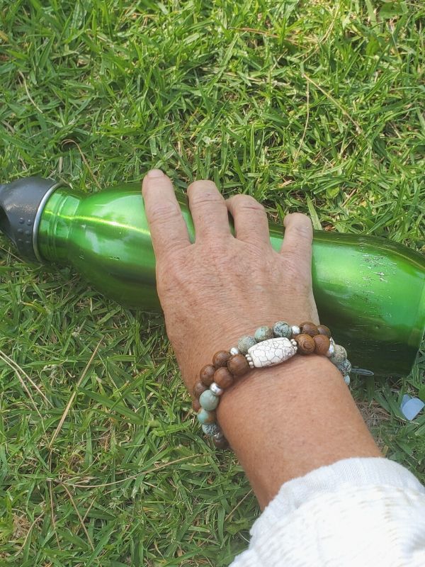aromatherapy bracelets on wrist in the grass