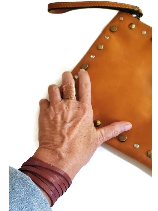 leather wrap bracelet on wrist with purse