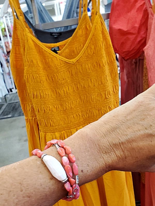 bright pink gemstone bracelet with orange dress from Target