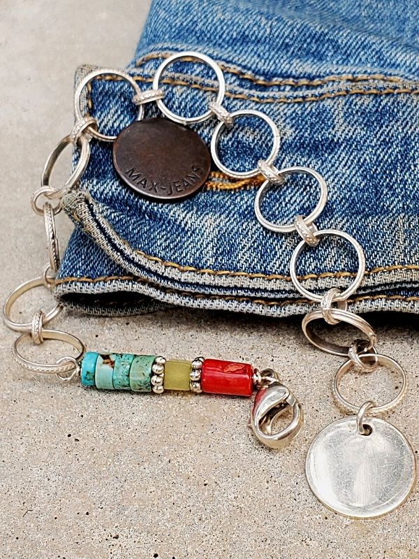 red, green, turquoise silver chain charm bracelet with blue jeans