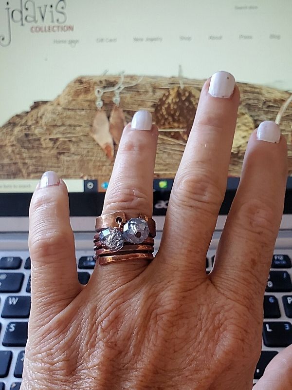 rings on finger at computer