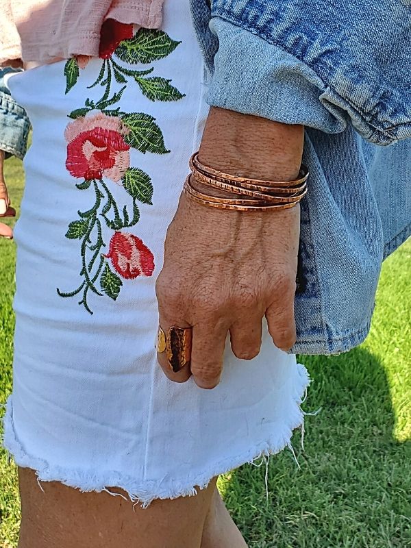 wearing textured copper cuff bracelets
