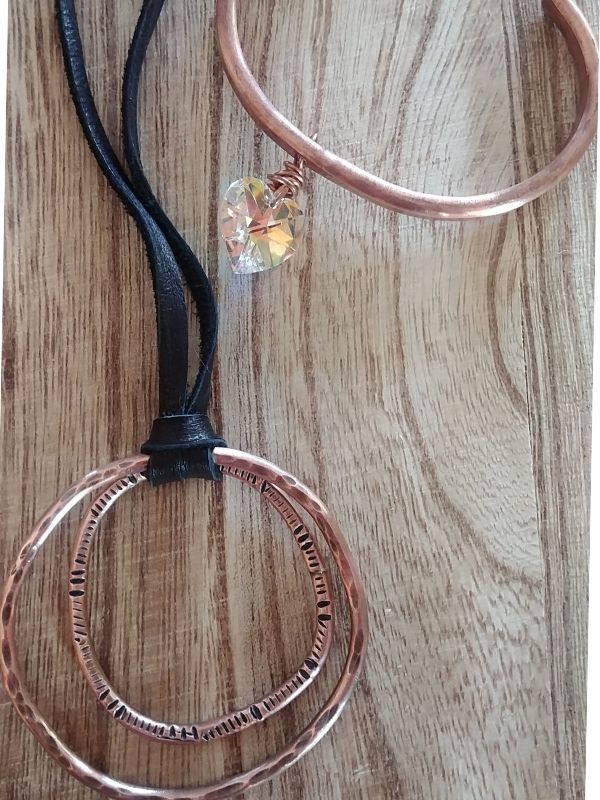 copper circle leather necklace & crystal heart cuff on wood