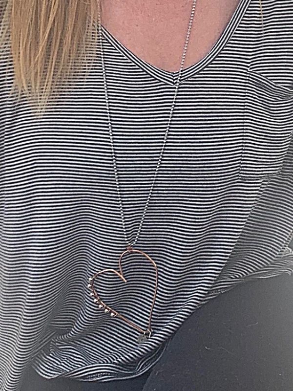 mixed metal heart necklace on striped tee