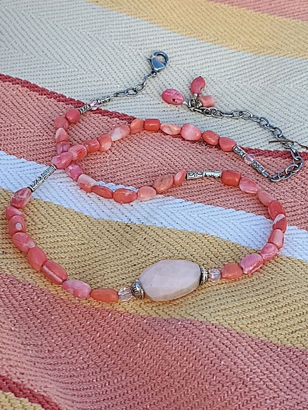 Pink gemstone necklace/bracelet on matching blanket