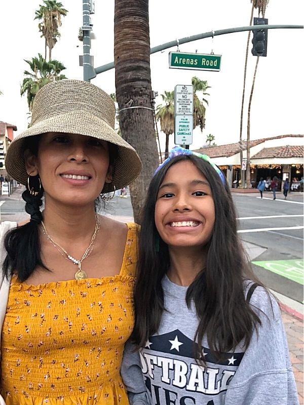 mom wearing coin necklace with daughter
