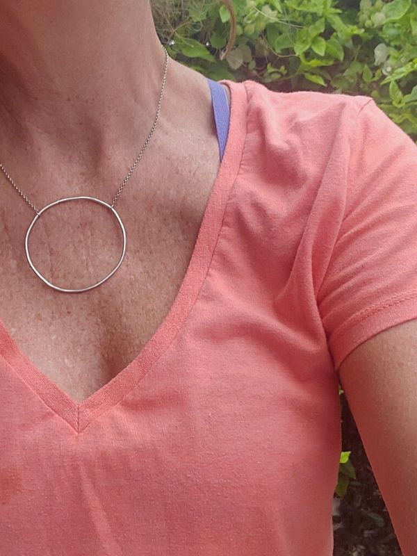 wearing big silver open circle necklace outside
