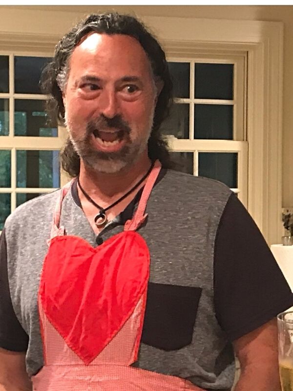 male wearing black leather ring necklace in the kitchen