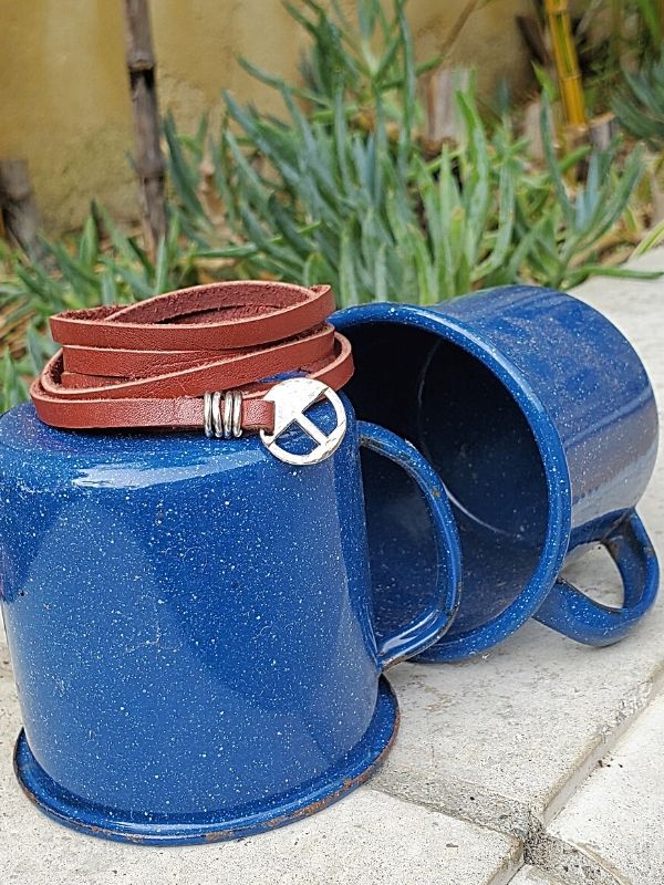 Leather multi wrap bracelet on camping mugs