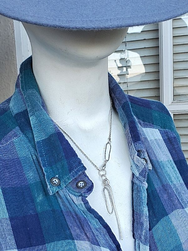 cool sterling necklace on mannequin with flannel shirt