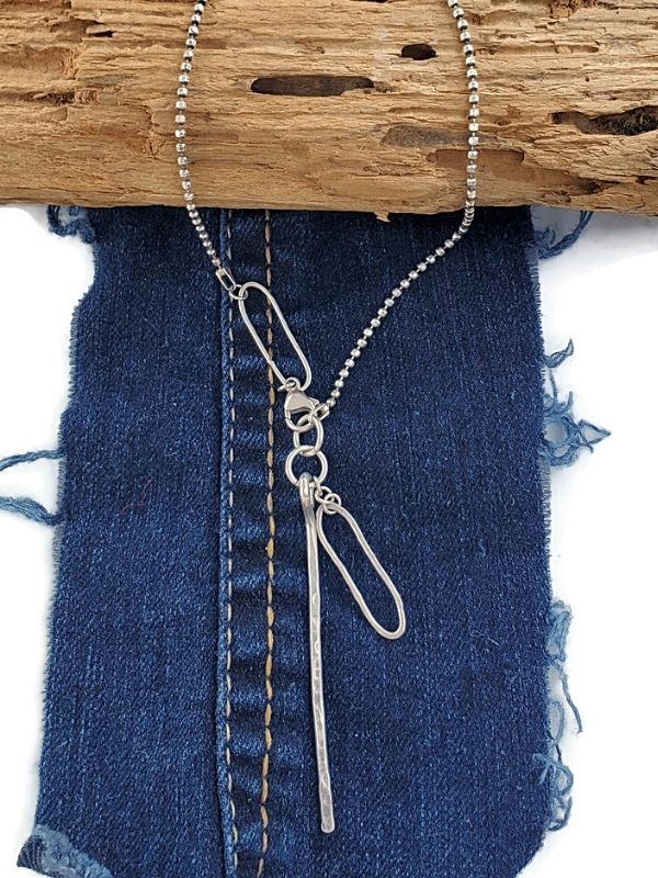 Artsy sterling silver asymmetrical necklace on denim