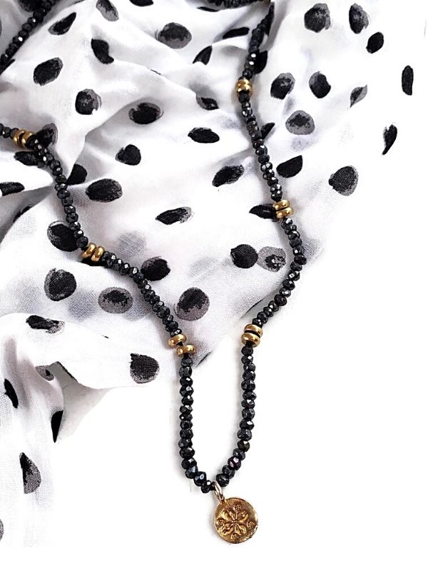 black necklace with a polka dot top