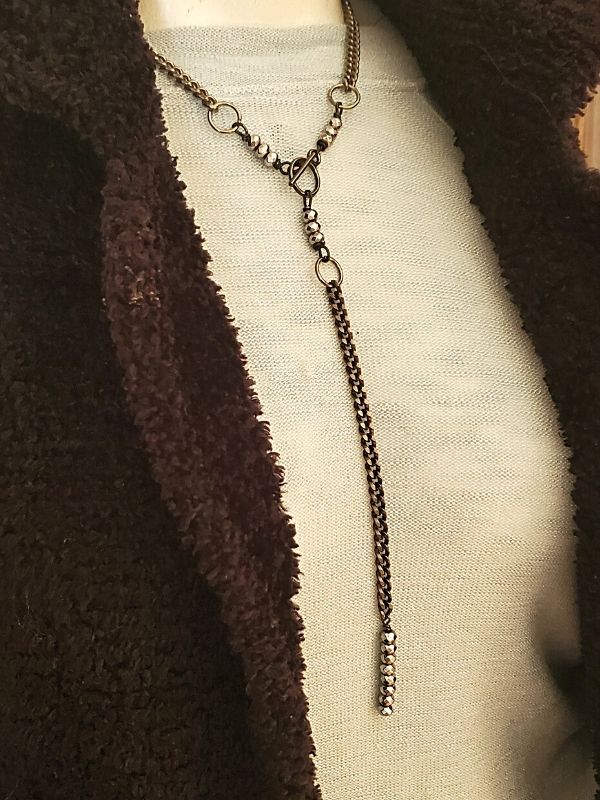 black chain Y necklace on mannequin