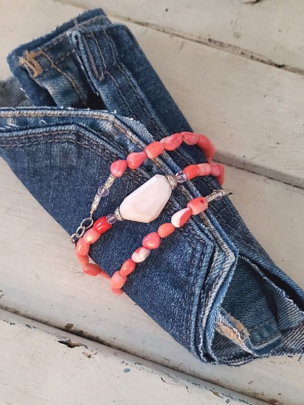 Pink gemstone bracelet wrapped on denim