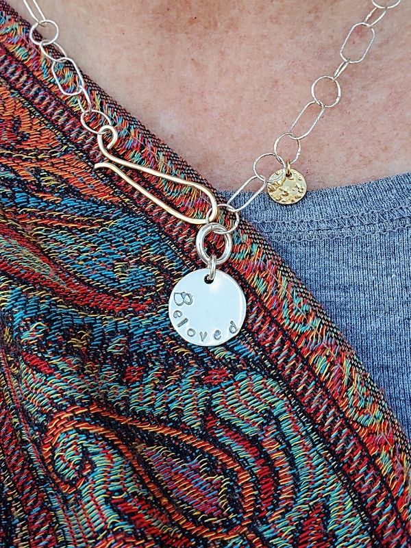 silver beloved necklace worn with scarf