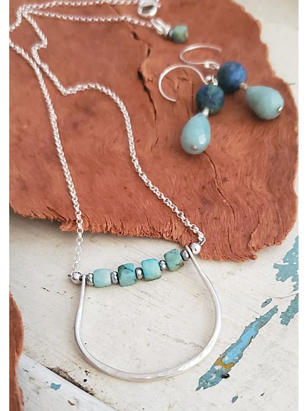 modern silver blue stone necklace set on wood