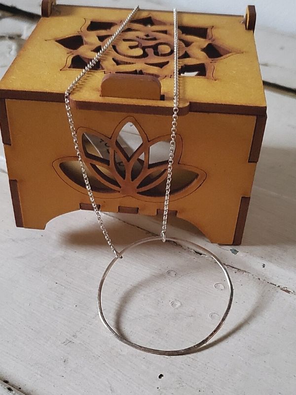 silver  open circle necklace with a prayer box