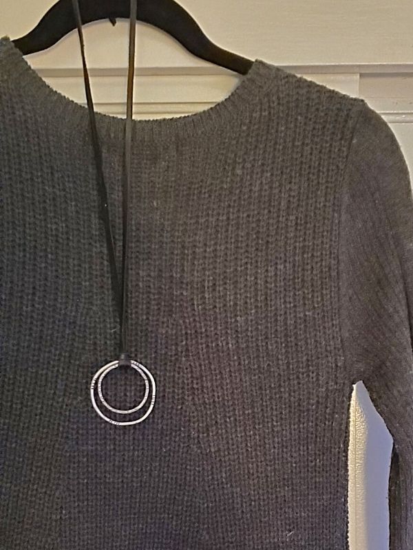 knit sweater dress with silver circle necklace on hanger