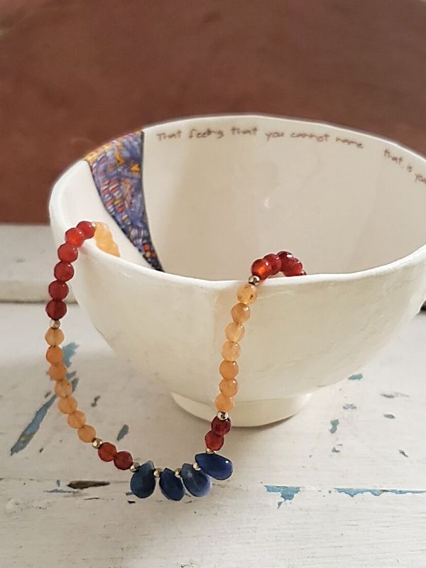colorful gemstone necklace with a Ruchi's ceramic dish