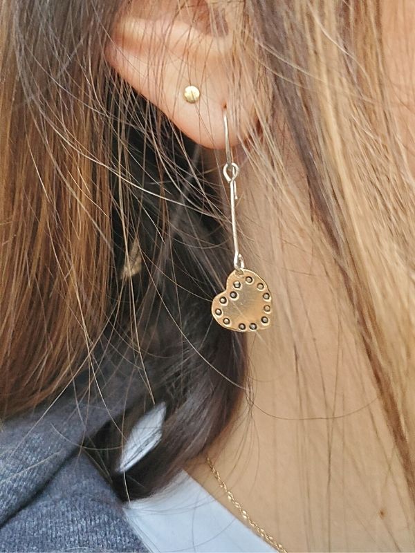 dotted heart stick earrings on ear