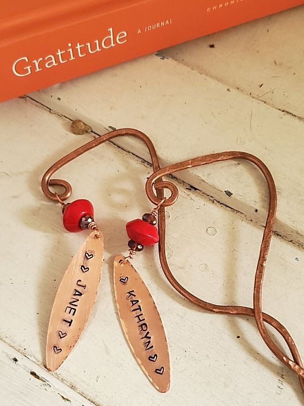 whimsical copper bookmarks with a book