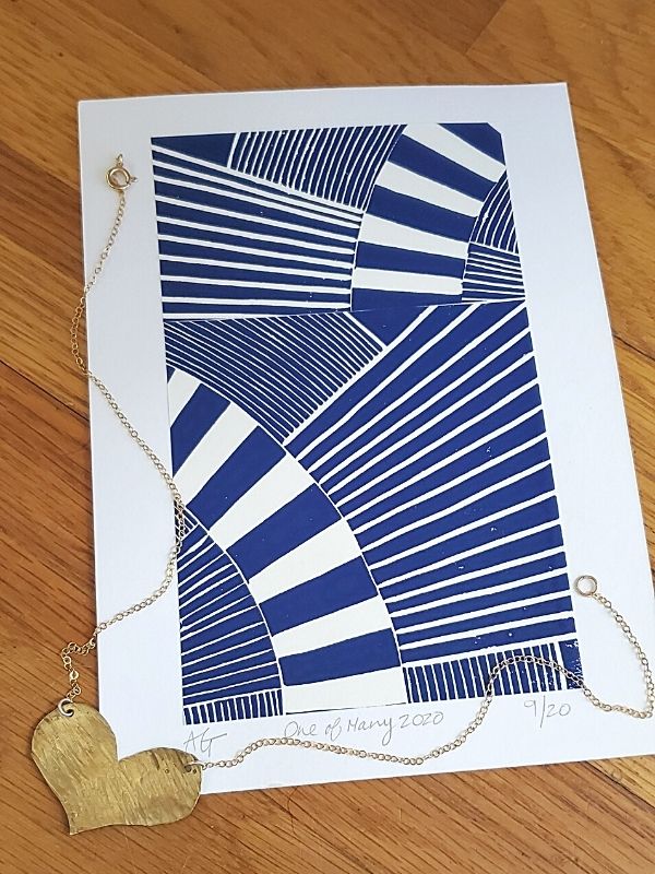 gold heart necklace with blue graphic print