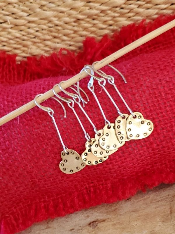 lots of heart stick earrings hanging in a row