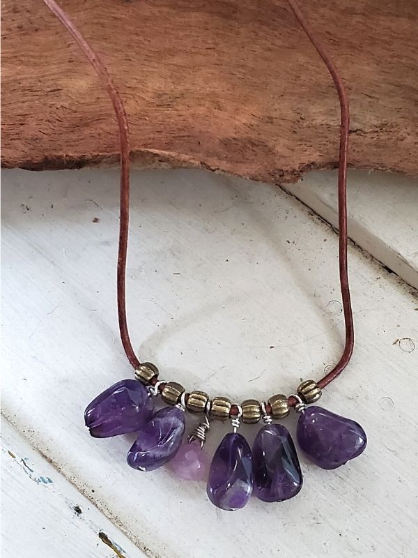 purple amethyst cluster necklace on white trunk