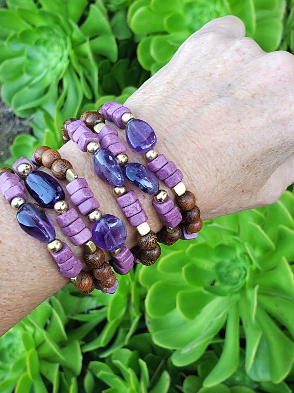 purple gemstone bracelet stack on arm over plants