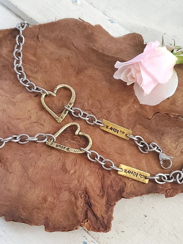 2 remembrance heart bracelets on wood with rose