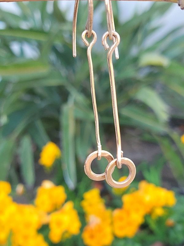 bronze stick circle earrings in garden