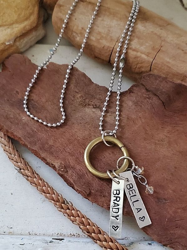 mom charm necklace on wood display