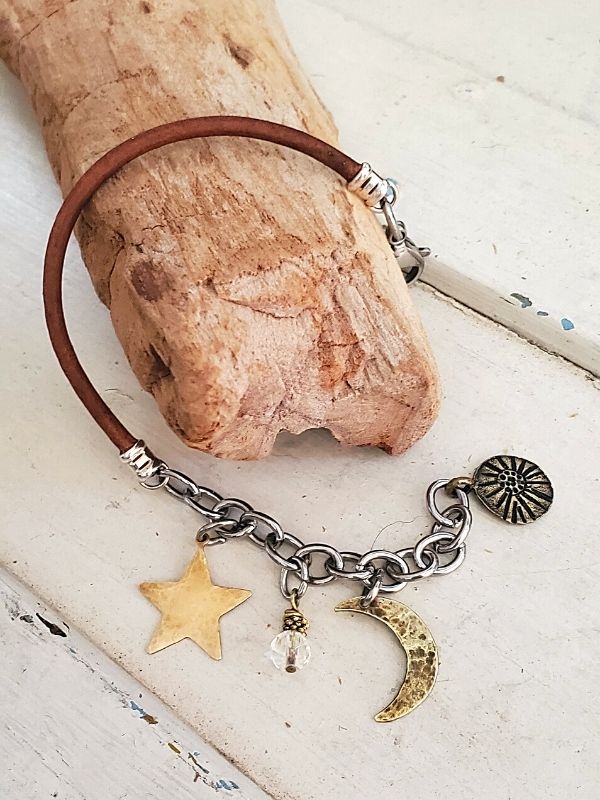 moon star bracelet on wood branch