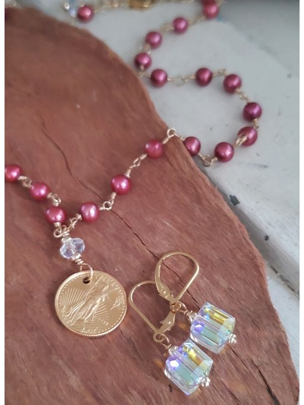 pink pearl gold coin necklace set on wood