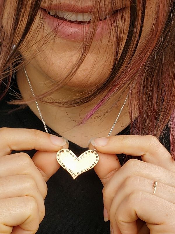 wearing & touching heart necklace