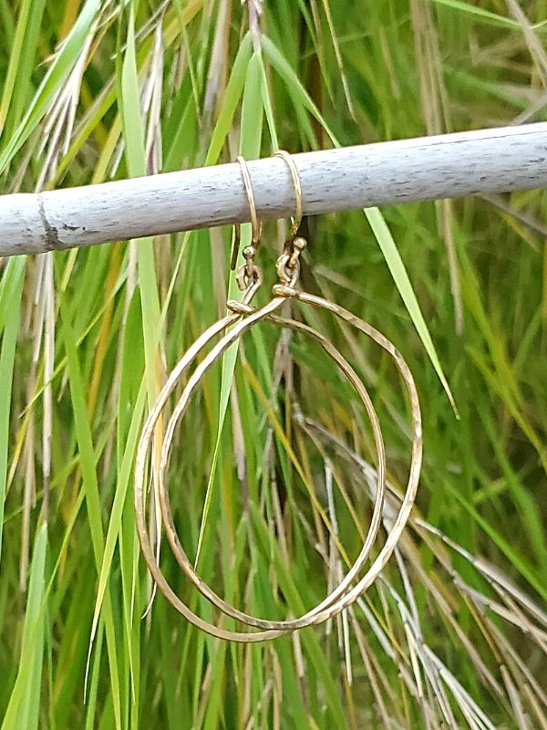 gold hoop earrings with plant 