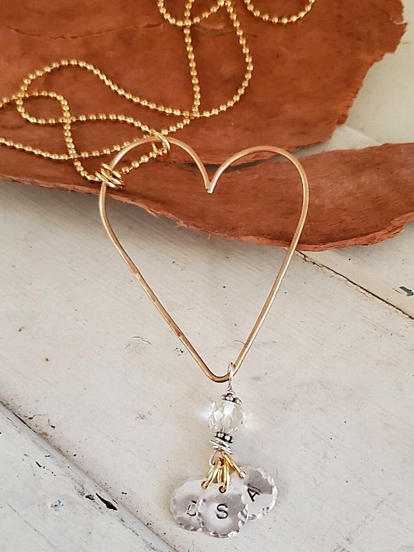 long heart charm necklace on trunk