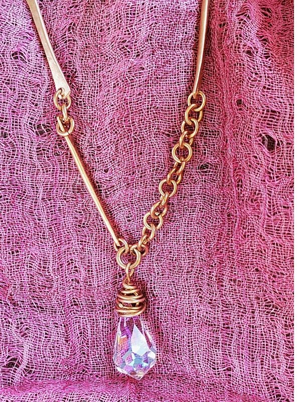 crystal forged bar chain necklace on pink fabric